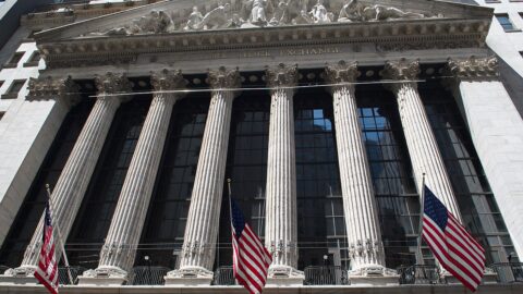 New York Stock Exchange facade with columns and flags