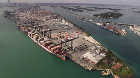 Aerial view of container port with cranes and cargo ship