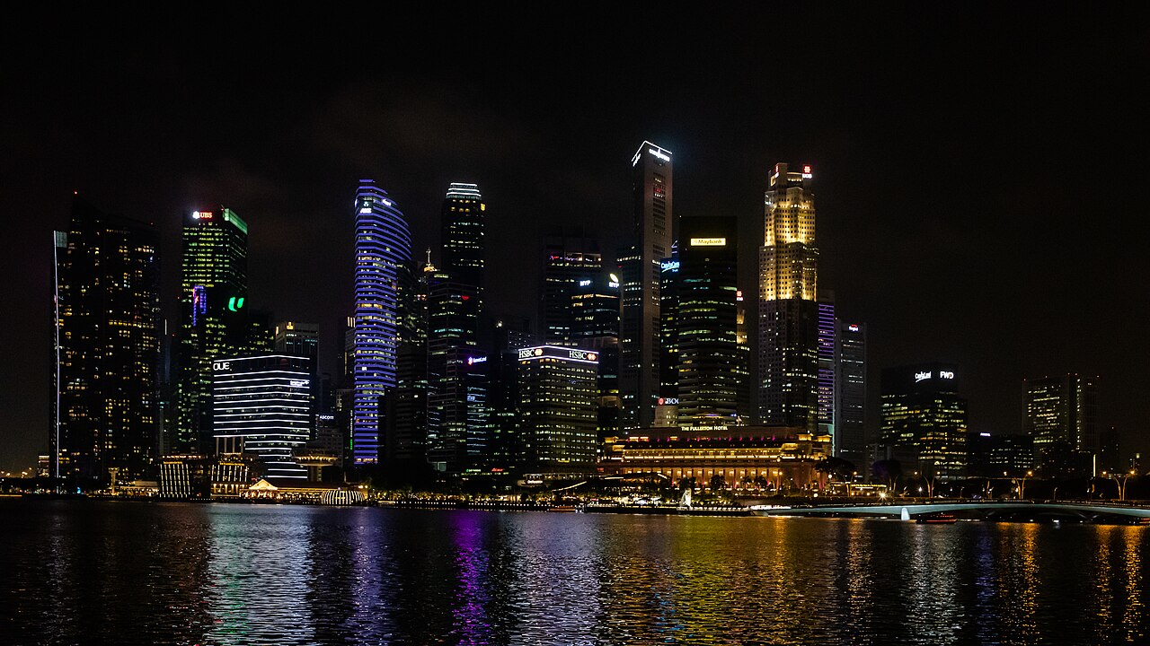 City business district skyline reflected at night