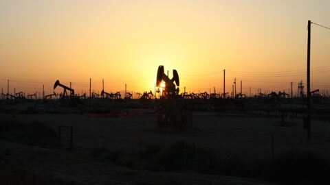 Oil pumpjacks silhouetted at sunset