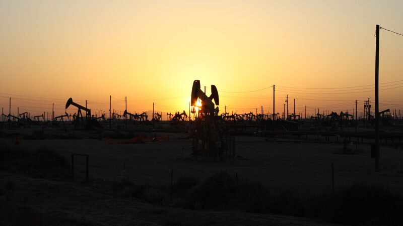 Oil pumpjacks silhouetted at sunset