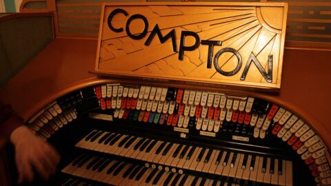 Compton theatre organ console with illuminated sign