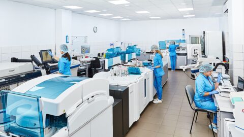 Scientists working with analysers in a laboratory