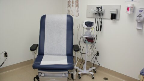 Ambulatory clinic examination room with couch and monitor
