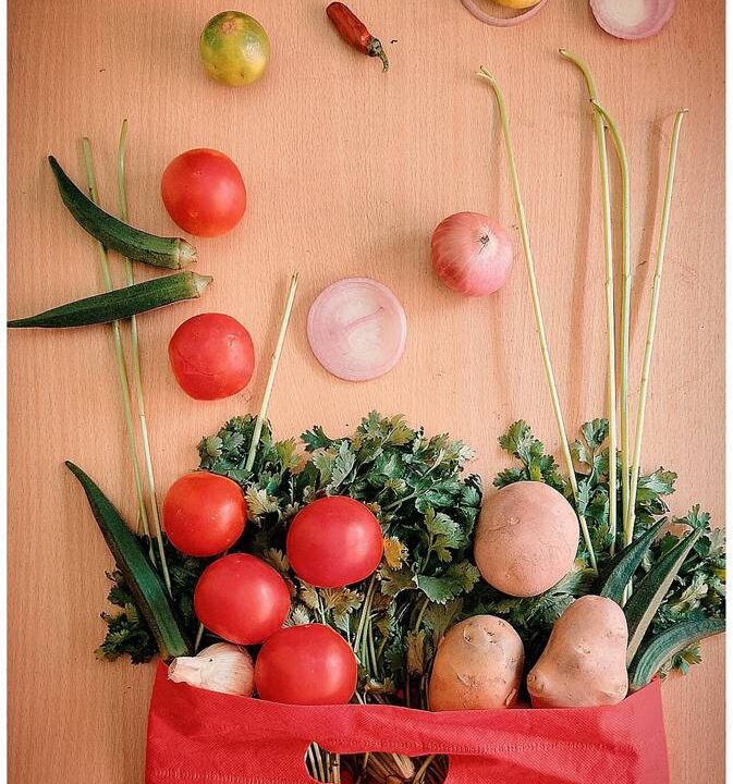 Bag of fresh vegetables and tomatoes from above