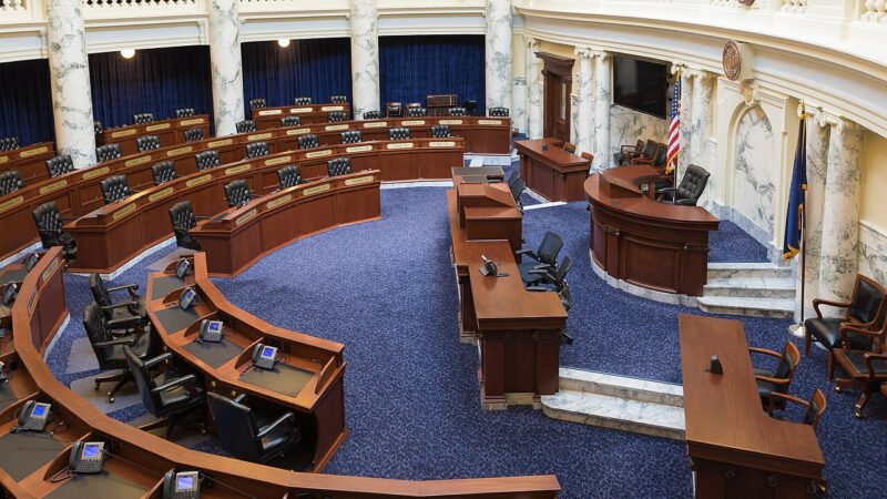 Legislative chamber with curved desks and blue carpet