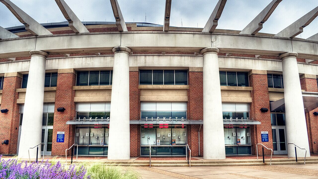Arena building exterior with columns in daylight