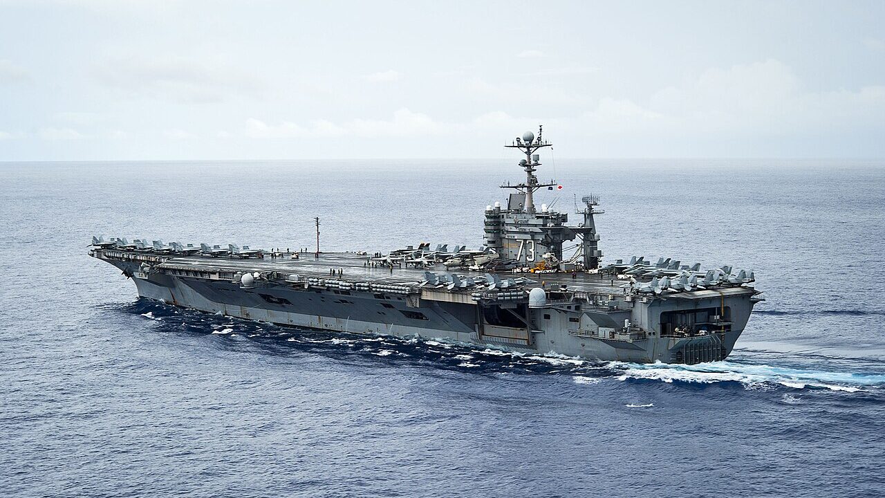 Aircraft carrier at sea under a hazy sky
