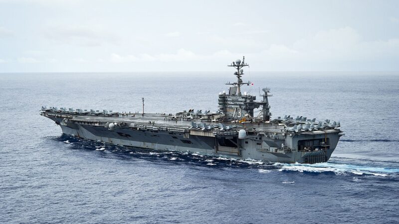 Aircraft carrier at sea under a hazy sky