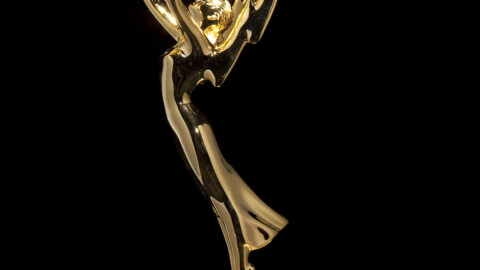 Gold Emmy Award statuette against a black background