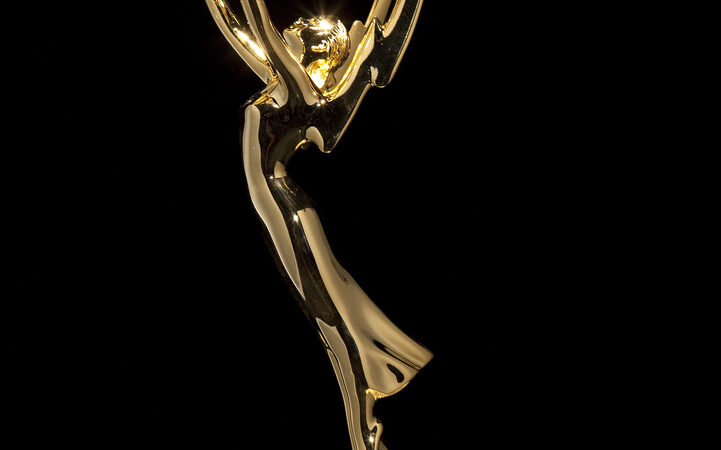 Gold Emmy Award statuette against a black background