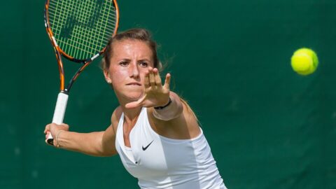 Annika Beck hitting a forehand during 2015 Wimbledon qualifying