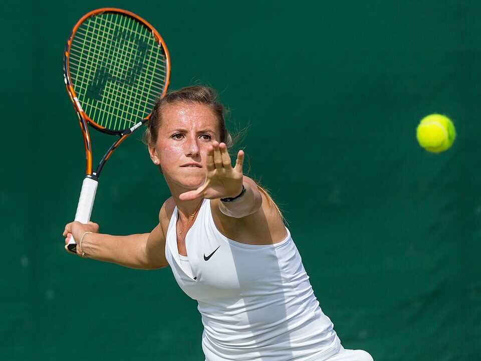 Annika Beck hitting a forehand during 2015 Wimbledon qualifying