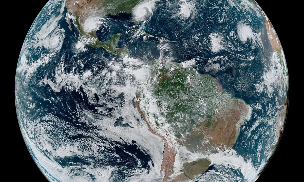 Satellite view of Earth showing storm systems over the oceans